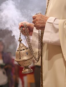 Why do priests burn incense at Mass and Adoration?