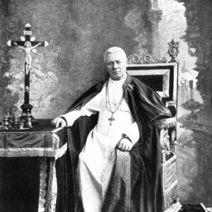 Who helped inspire Pope Pius X to lower the age for First Communion?